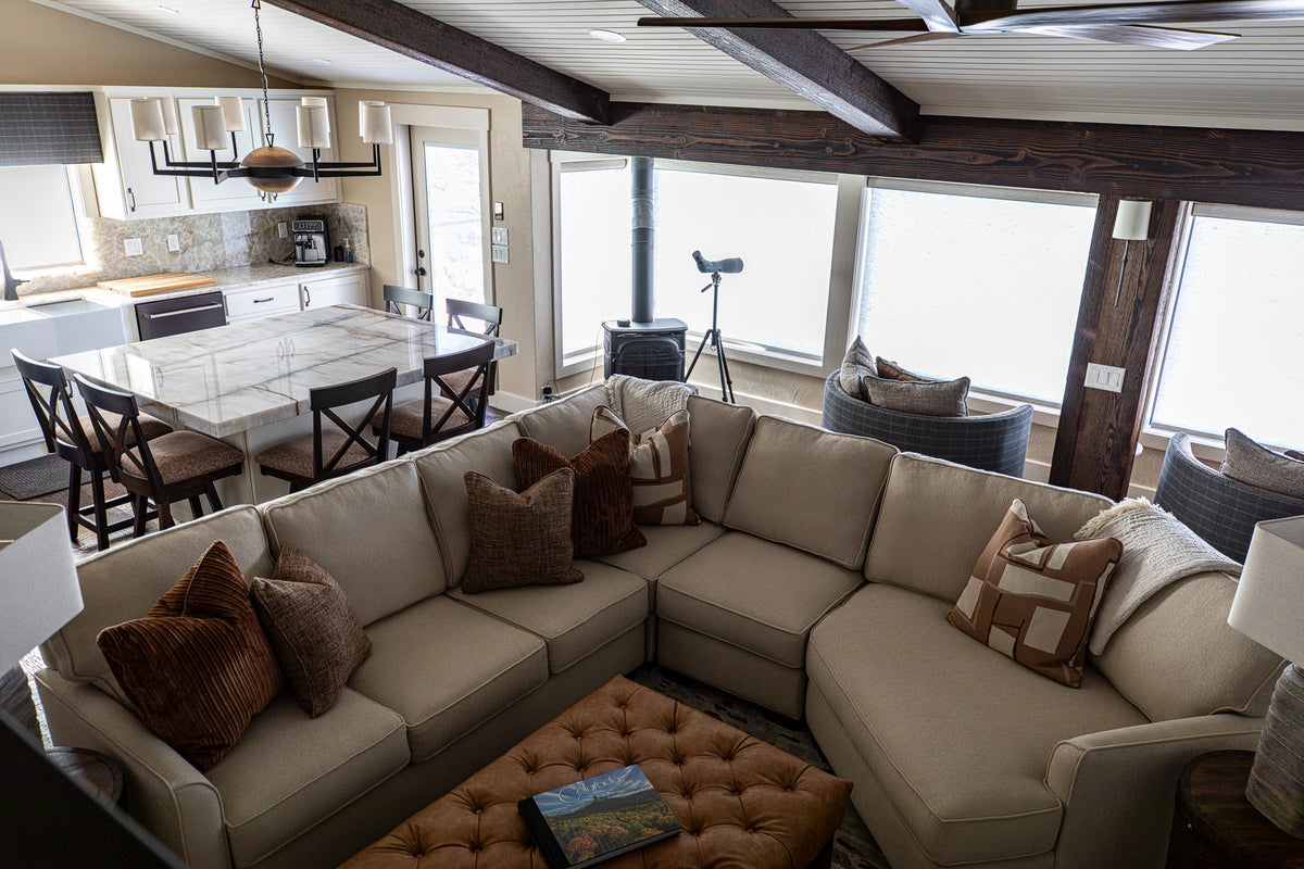 Mountain modern living room with sectional under dark timber beams, Overlook project, Colorado foothills