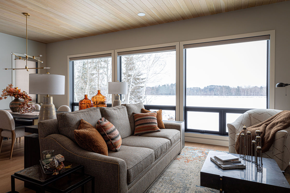 Mountain modern living room with neutral sofa and large lake-view windows, Black Diamond project