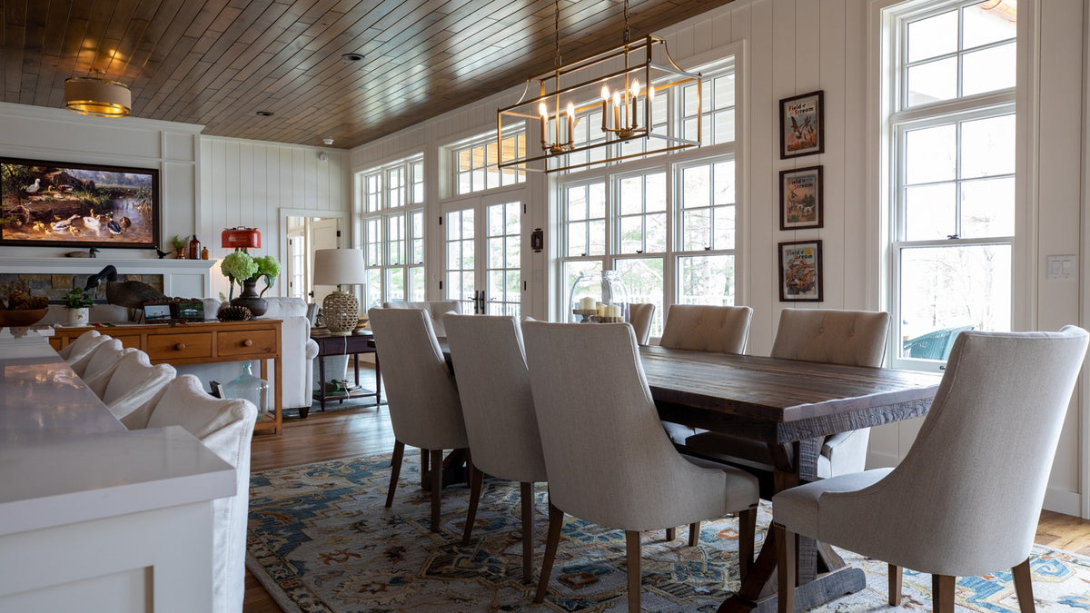 New Traditional dining room with white paneled walls, linen dining chairs and a trestle table, Duck Lake Landing project