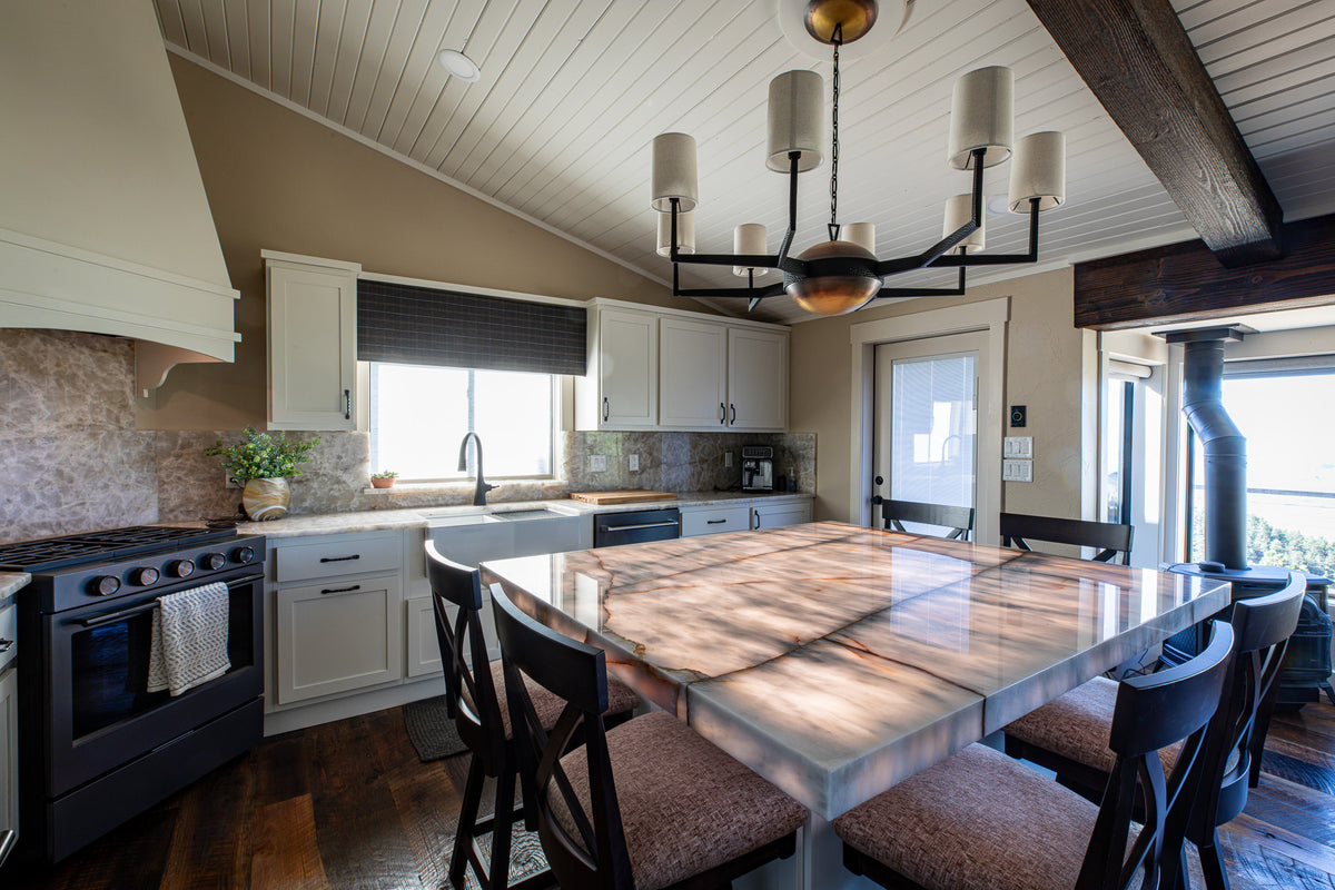 White kitchen with iron chandelier and dark timber beams, Overlook project, Colorado foothills