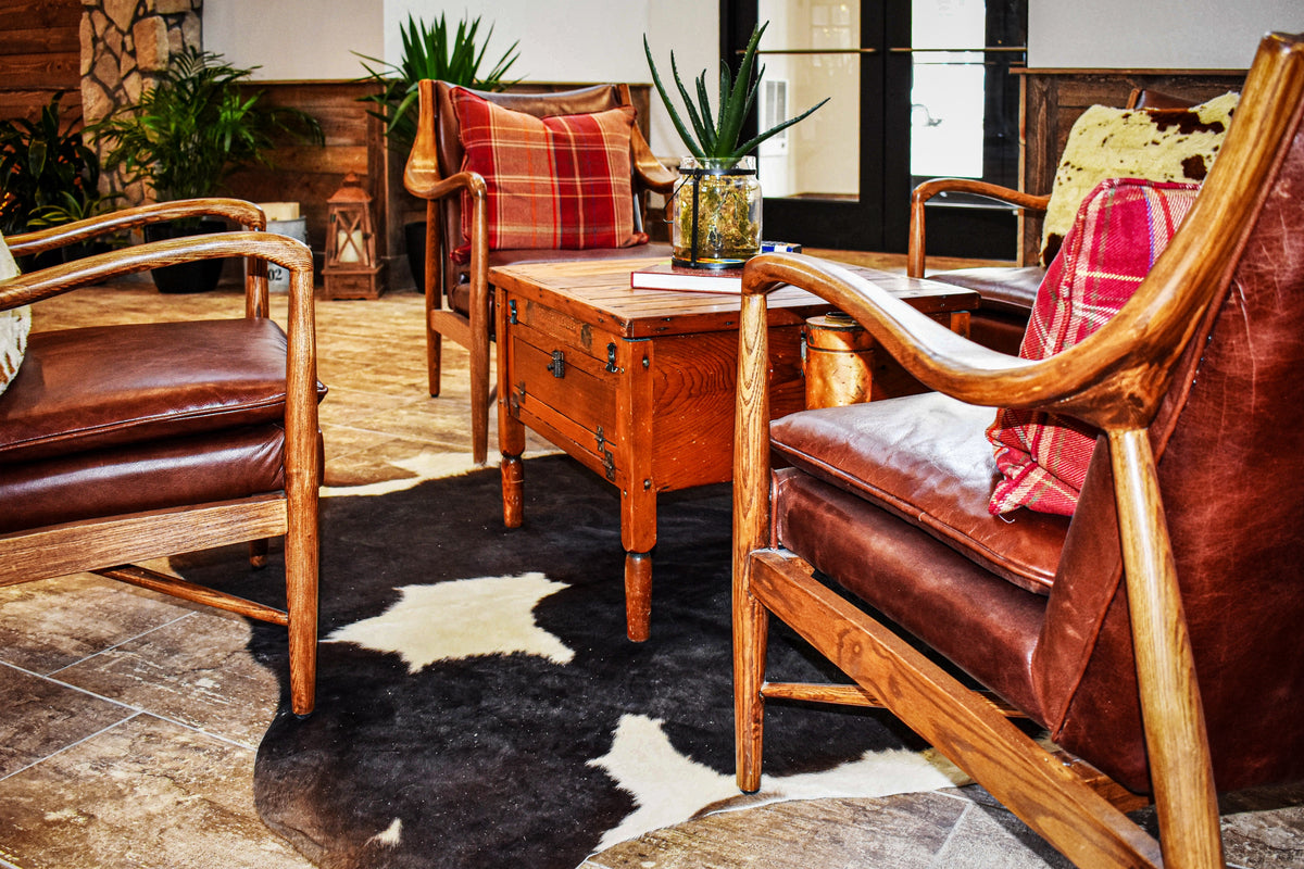 Leather and wood armchairs on a cowhide rug, Bucking Horse project, Northern Colorado