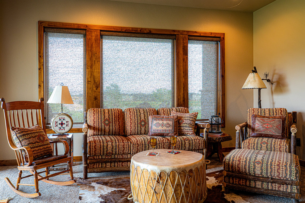 Western living room with striped sofa, rocking chair and drum table, Winter Peak project, Timnath, CO