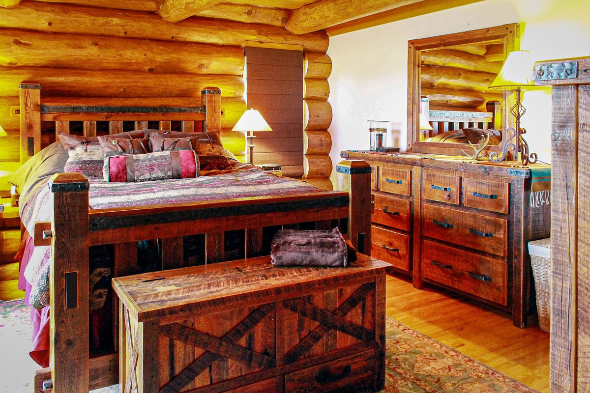 Log-walled bedroom with a timber bed, matching dresser and storage chest, Beresford Lodge project, Eastern Wisconsin