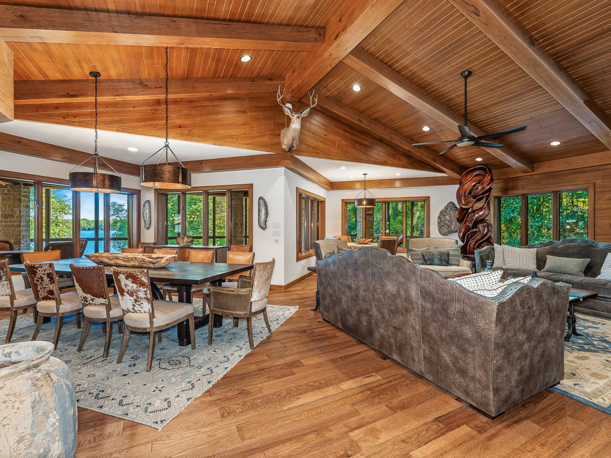 Lake home living and dining room under a beamed wood ceiling with lake views, Copperline project, Eagle River, Wisconsin