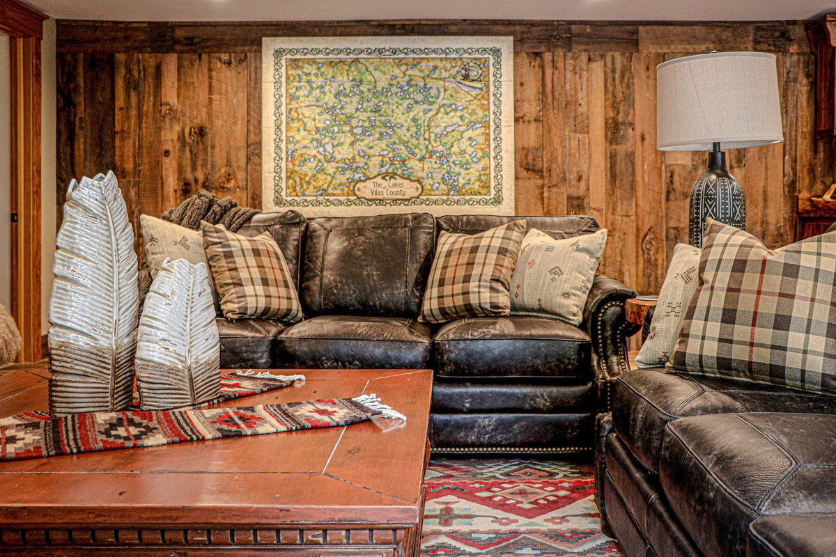 Leather sectional in a wood-paneled room under a framed map, Moose Hollow project, Northern Wisconsin
