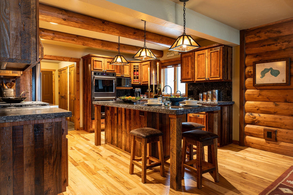 Log home kitchen with a barnwood island and pendant lights, Big Hills project