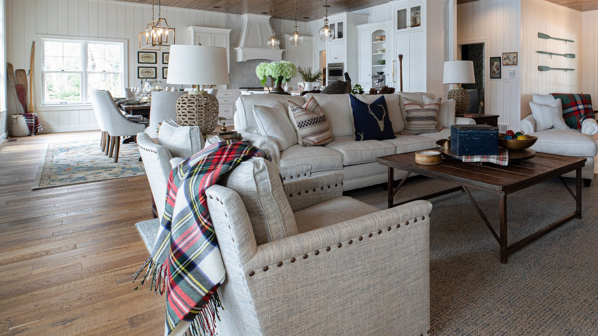 New Traditional great room with nailhead-trim linen sofas, plaid throw and white paneled walls, Duck Lake Landing project