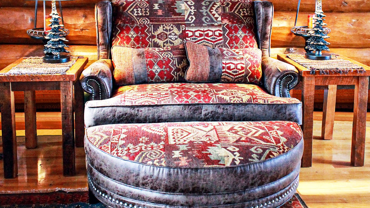 Chair and ottoman in red Southwest kilim fabric and distressed leather, with pine-tree lamps, Beresford Lodge project